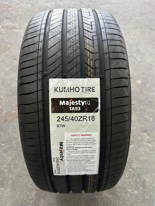 A new KUMHO TA93 MAJESTY9 tyre with the label visible, showing tread pattern and branding.