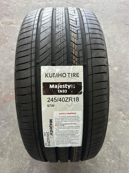 A new KUMHO TA93 MAJESTY9 tyre with the label visible, showing tread pattern and branding.