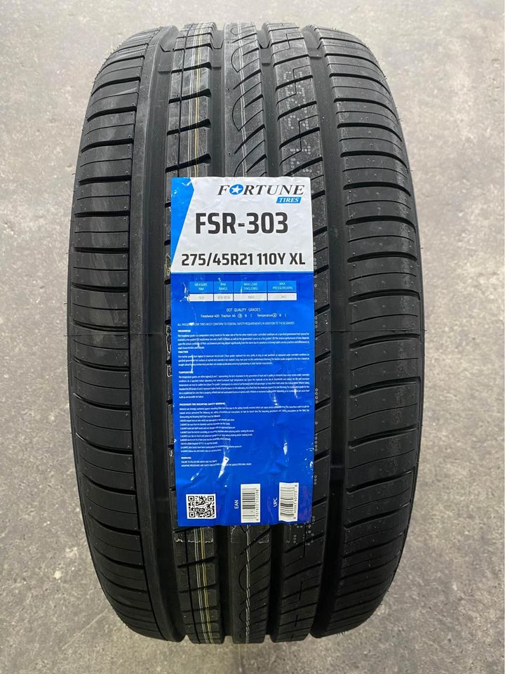 A black tire with a label indicating it is a Fortune FSR-303 tire, with the size 275/45R21 and additional details such as tread pattern and brand information.